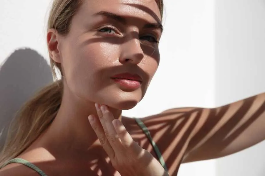 woman with palmleaf shade in face